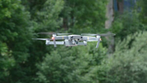 Es ist eine Drohne (Quadrocopter) mit beweglicher Kamera zu sehen. Sie fliegt knapp an uns vorbei.